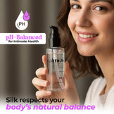Woman holding a bottle labeled 'calmras' with pH-Balanced branding and text about body health.