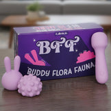 Purple packaging of Buddy Flora Fauna with pink rabbit-like figures on a wooden surface By calmras