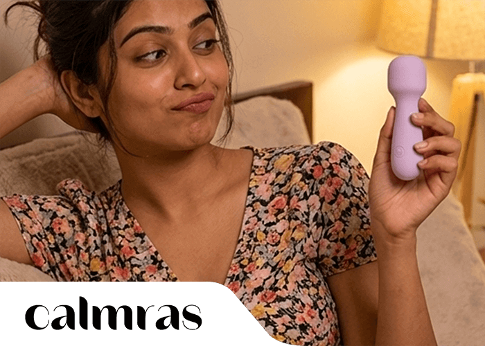 Woman holding a purple handheld BFF Massager in a cozy indoor setting by Calmras Brand